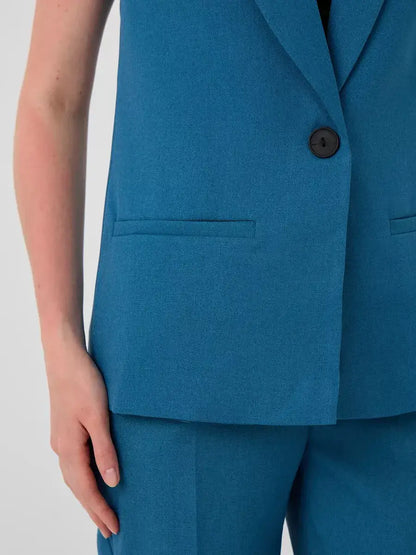 Marine Suit Set by Lauven – Close-up of sleeveless teal vest showcasing tailored design.