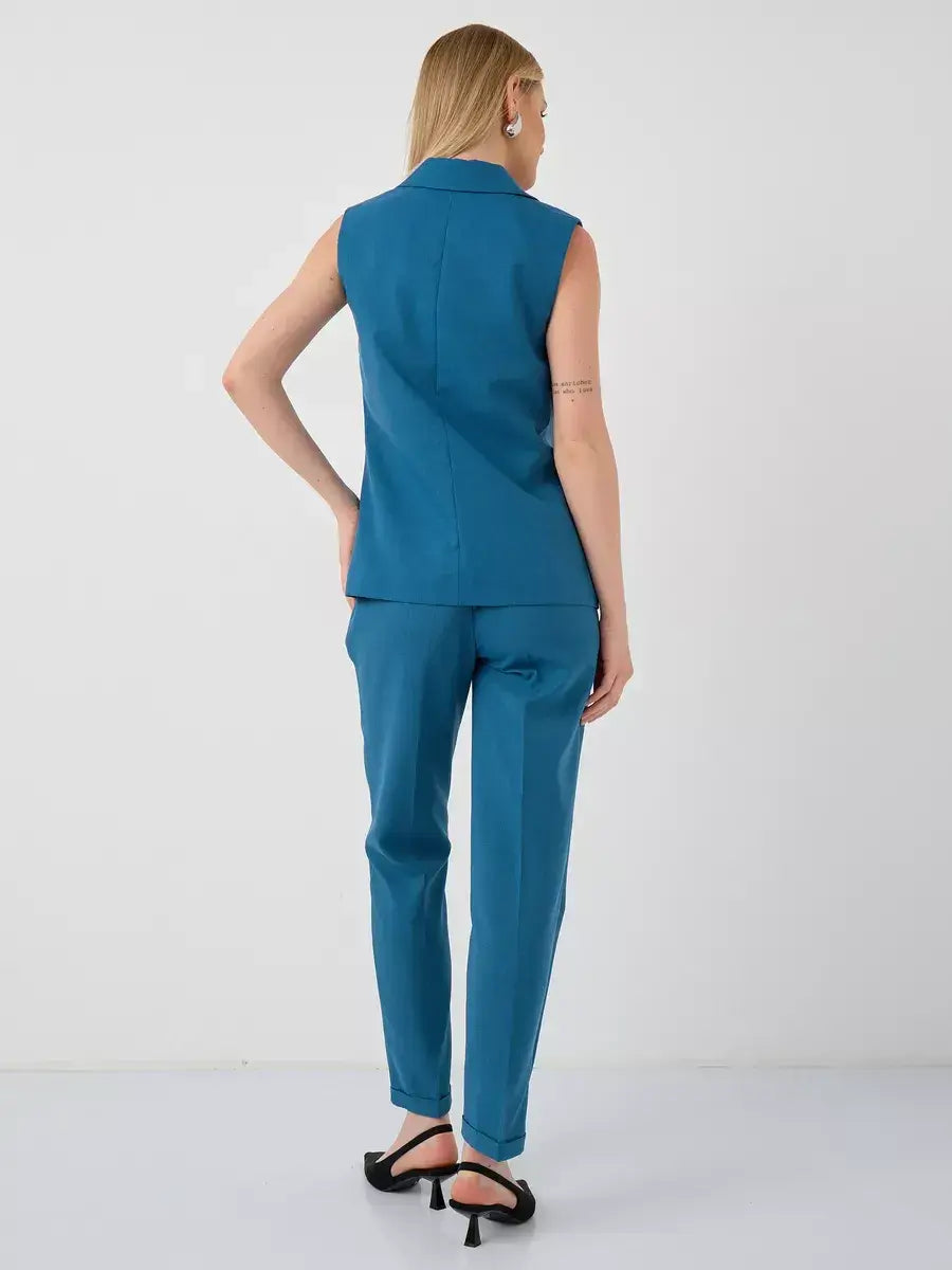 Marine Suit Set by Lauven, featuring a sleeveless teal vest and high-waist pants from the back view.
