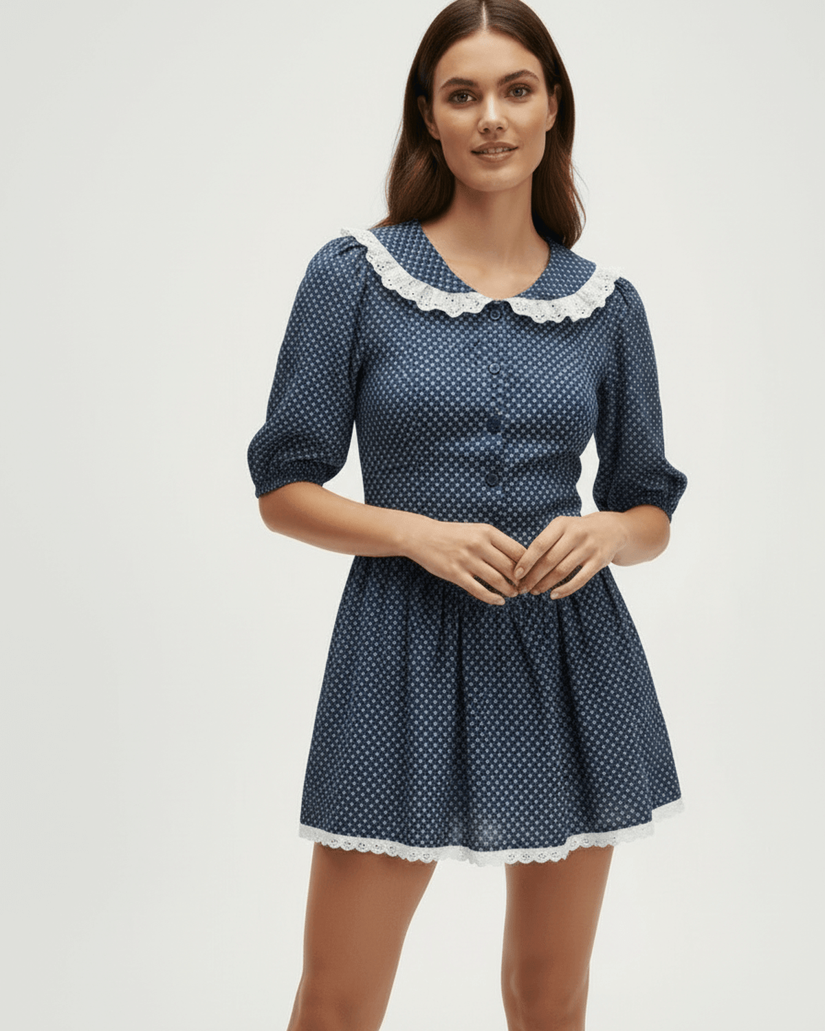 Marinette Mini Dress by Lauven featuring a Peter Pan collar and puff sleeves in navy blue with polka dots.