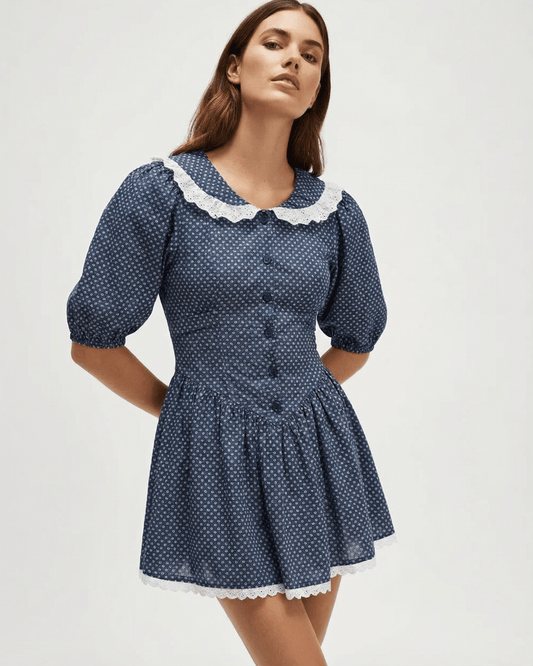 Marinette Mini Dress by Lauven featuring a Peter Pan collar and puff sleeves in navy blue with polka dots.
