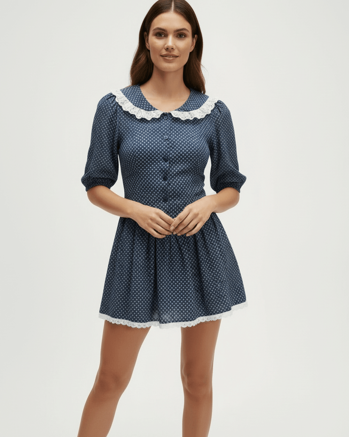Marinette Mini Dress by Lauven featuring a Peter Pan collar, puff sleeves, and a slim fit in navy blue with polka dots.