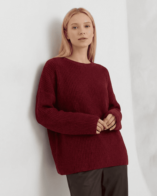 Marlo Sweater by Lauven - Loose fit ribbed knitwear in burgundy on a model in a cozy setting.