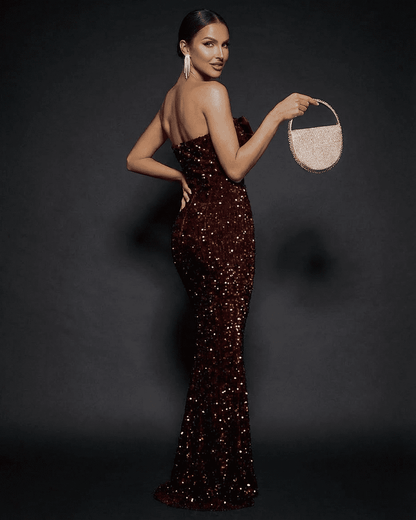 Stunning model showcases the Marquise Maxi Dress by Lauven, a strapless sequined gown with a thigh-high slit.