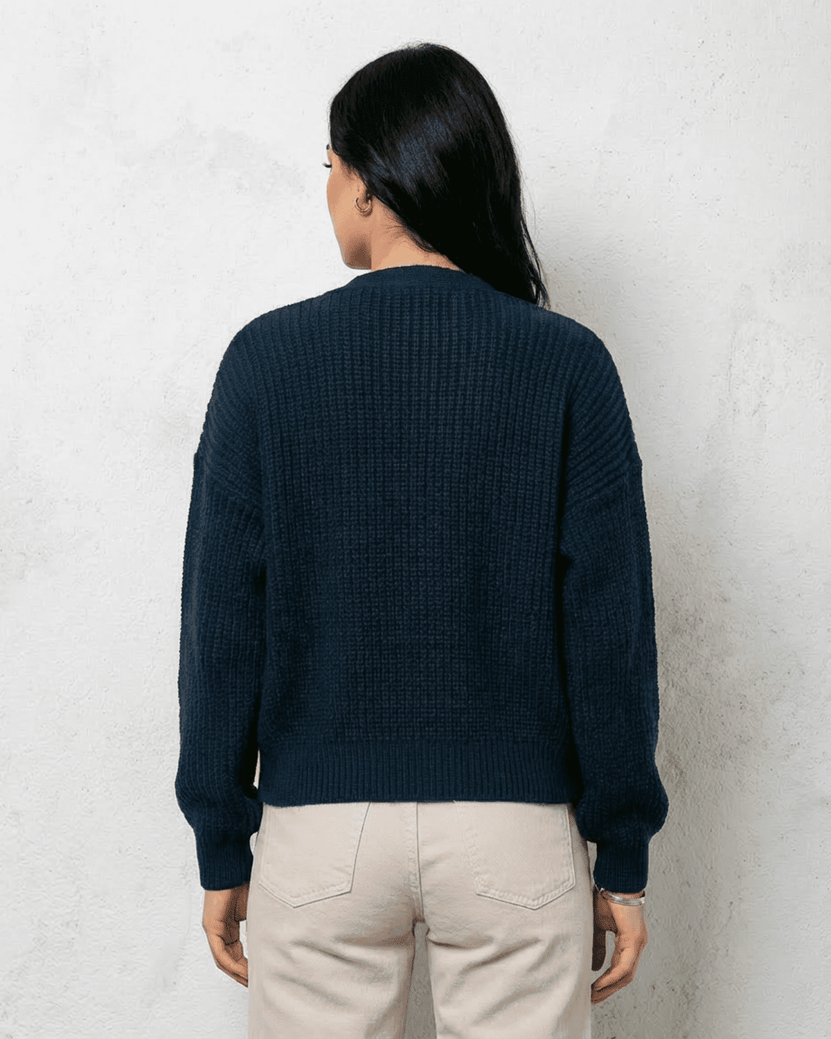 Back view of a woman wearing the Midnight Cardigan in deep navy by Lauven, showcasing its relaxed fit and classic design.