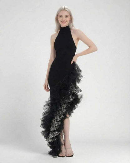 Monaco Maxi Dress by Lauven, a chic black halter neck dress with asymmetrical ruffle detail.