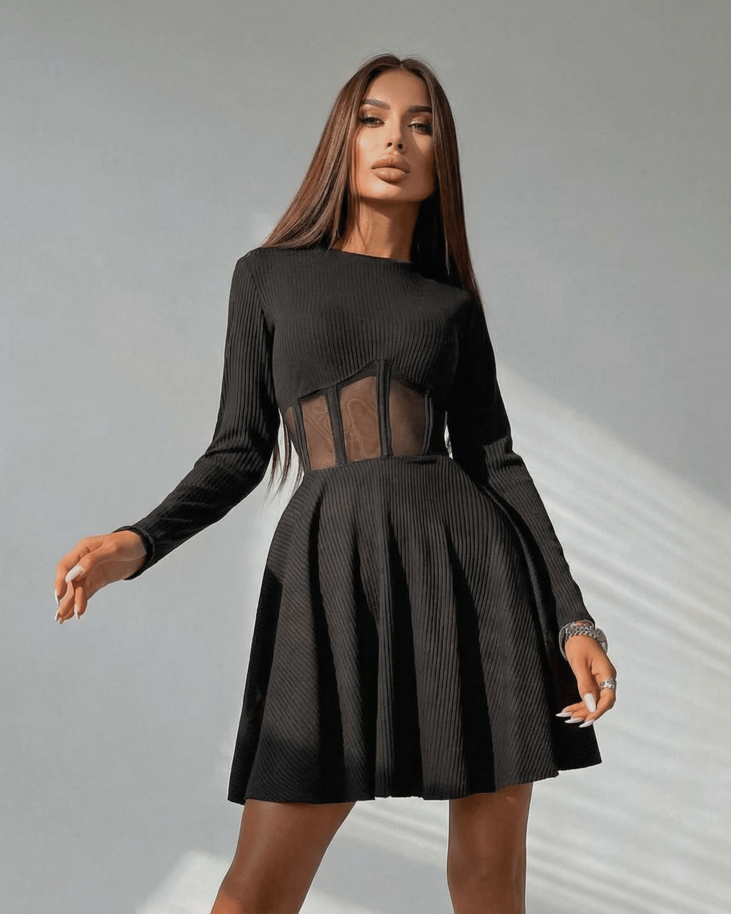 Lauven Monaco Mini Dress in black, featuring long sleeves and sheer corset panel, showcasing a stylish A-line silhouette.