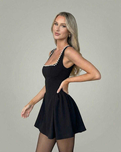 Monaco Mini Dress by Lauven featuring a sleek square neckline with pearl accents, crafted in a smooth black fabric.