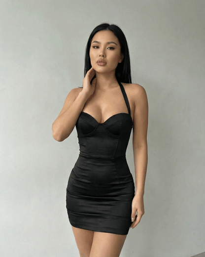 Monaco Mini Dress - Lauven brand model wearing sleek black satin bodycon halter cocktail mini dress.