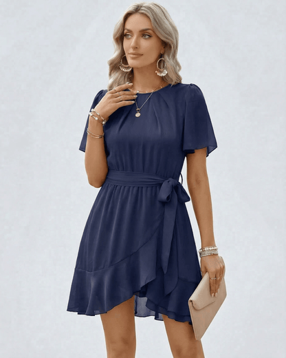 Navy Ruffle Dress by Lauven with waist tie, flutter sleeves, and soft ruffle hem, perfect for elegant occasions.