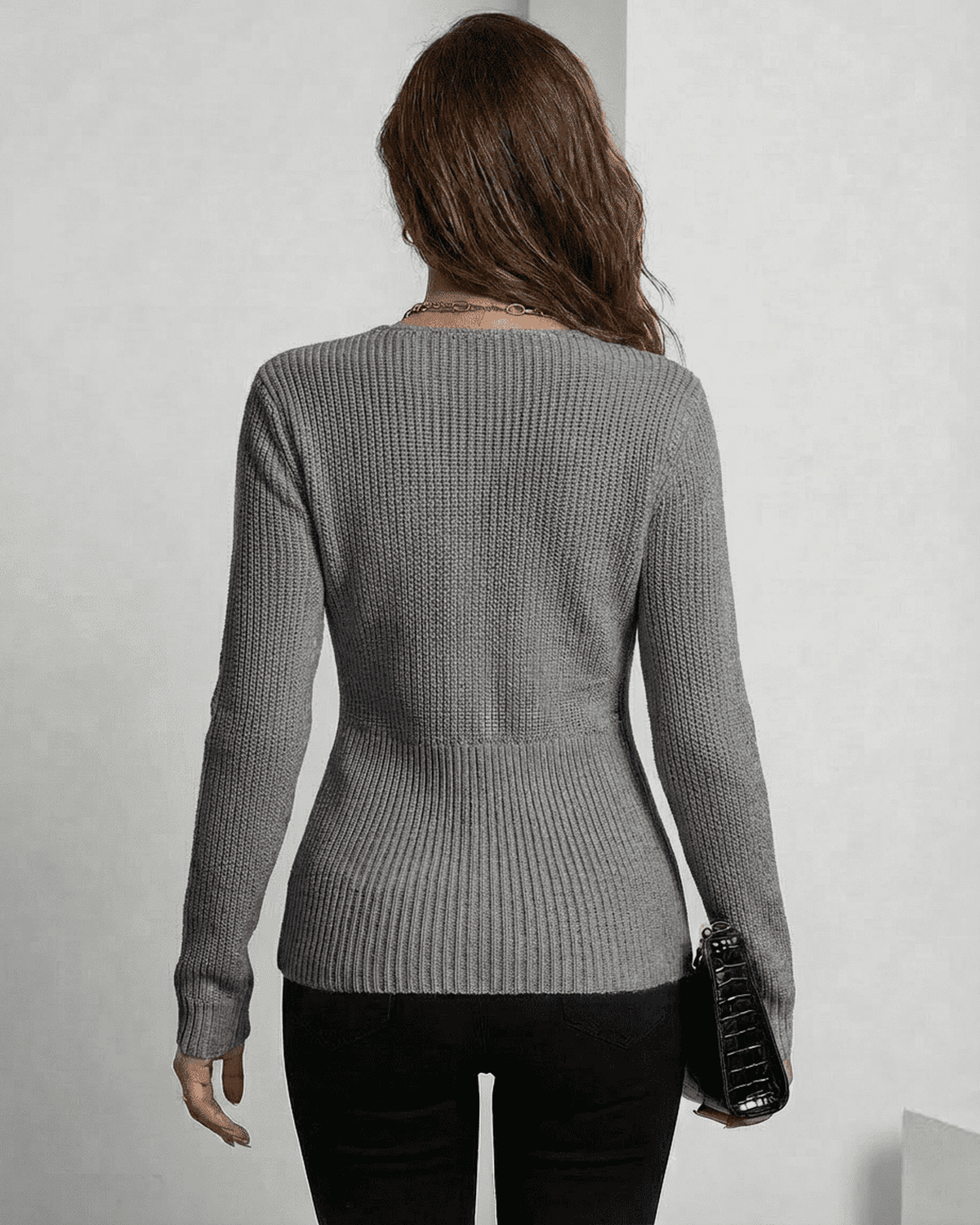 Back view of a woman wearing the Lauven Nerina Pullover in elegant grey, showcasing its refined ribbed slim fit.