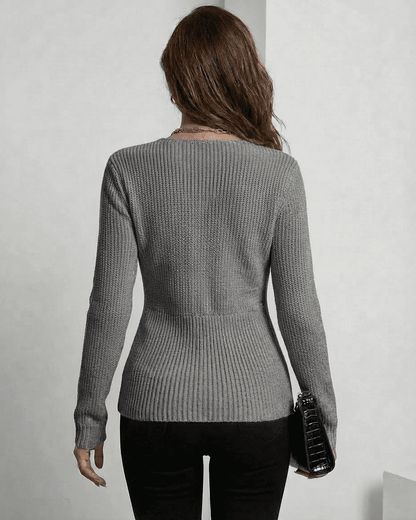 Back view of a woman wearing the Lauven Nerina Pullover in elegant grey, showcasing its refined ribbed slim fit.
