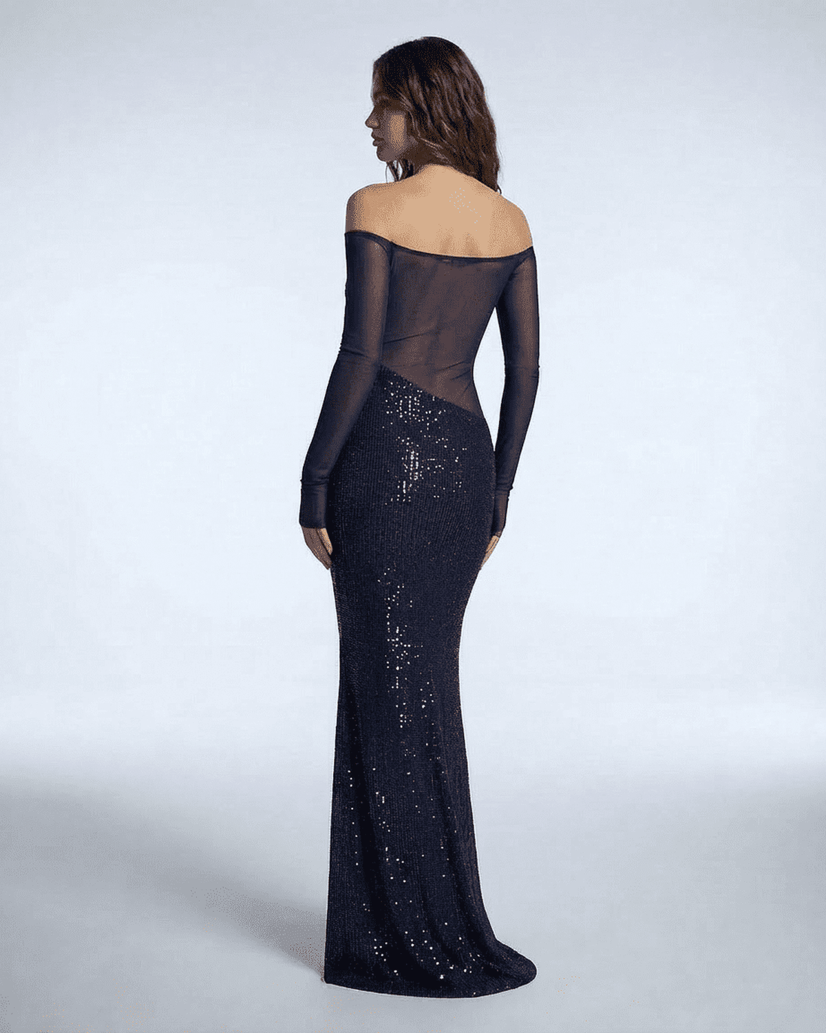 Back view of Noctura Maxi Dress by Lauven, showcasing its navy blue sequins and sheer mesh design.