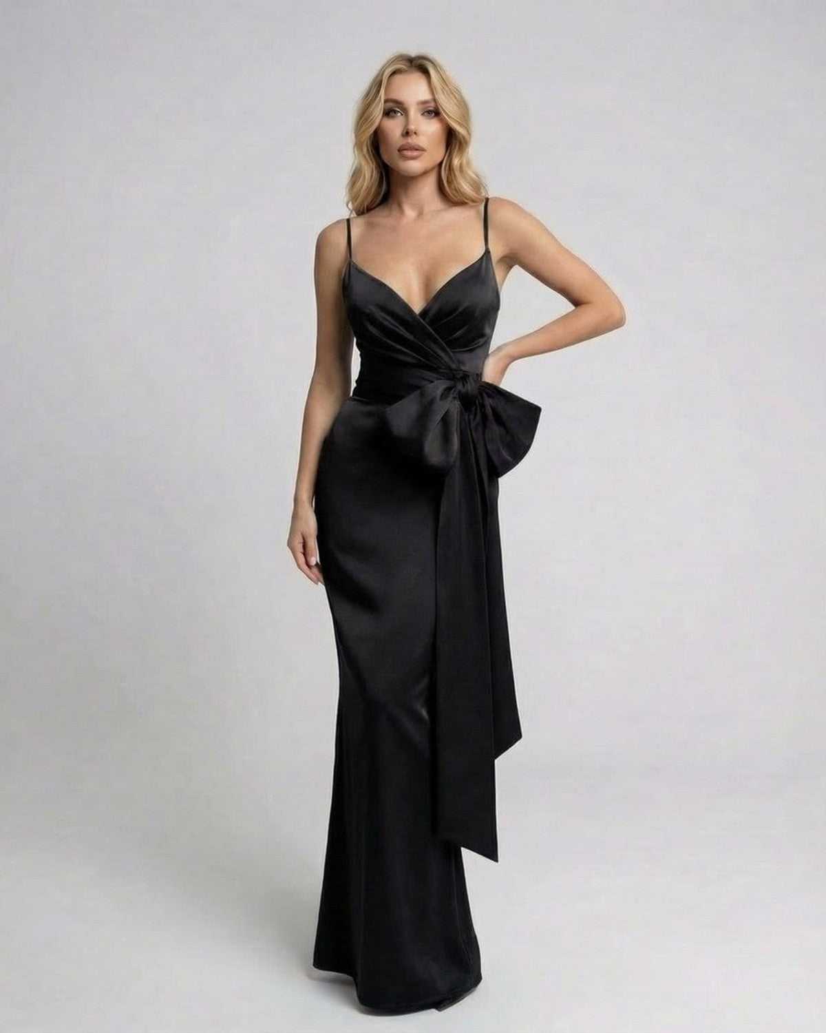 Nocturne Maxi Dress by Lauven, asymmetrical sleeveless design with a statement bow and sleek black finish.