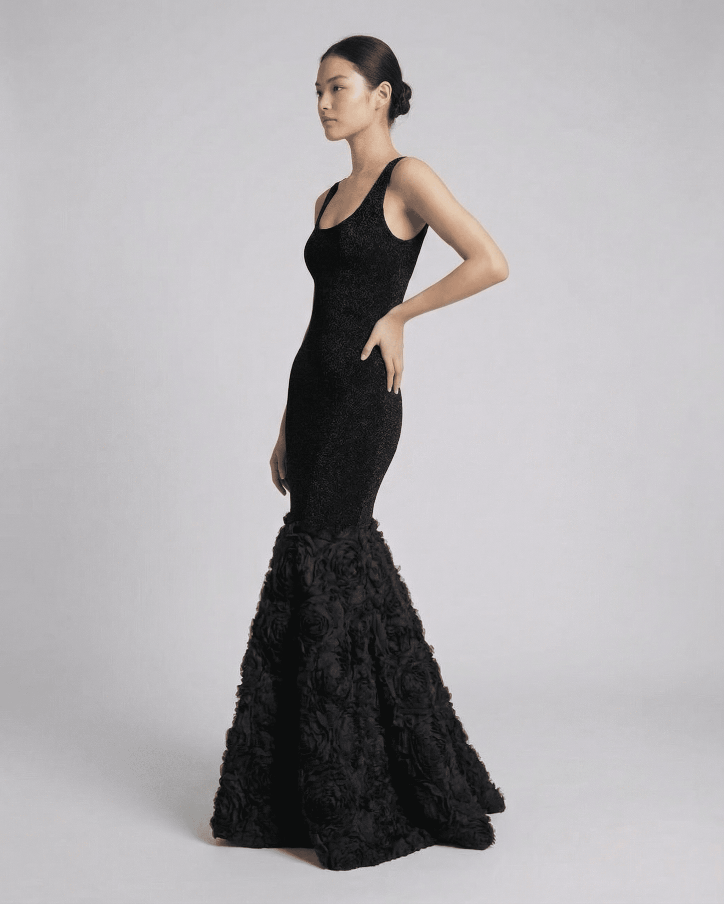 Nocturne Maxi Dress by Lauven, showcasing a sculpted silhouette with a textured hem detail in elegant black.