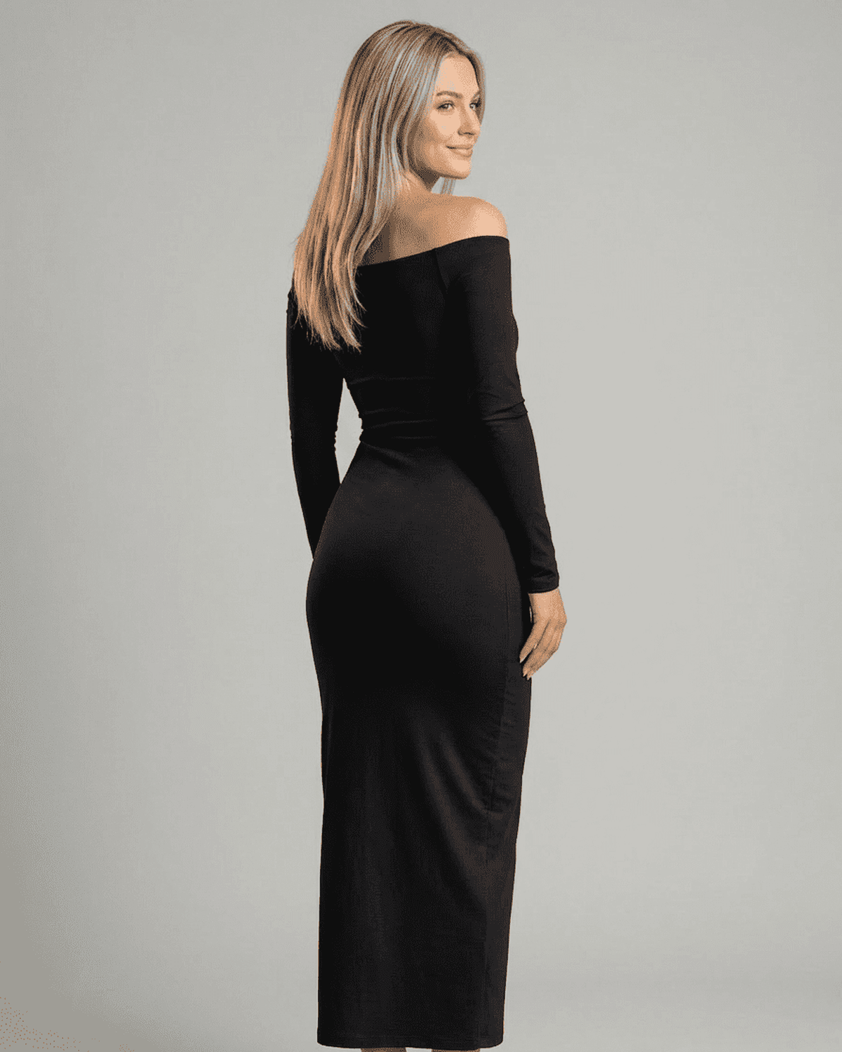 Model showcasing the Nocturne Maxi Dress by Lauven, featuring an elegant off-shoulder design and long sleeves.