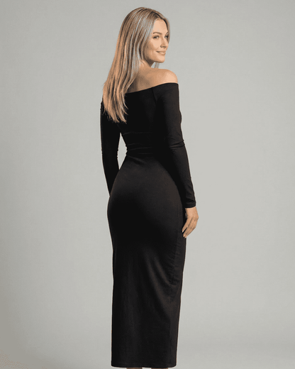 Model showcasing the Nocturne Maxi Dress by Lauven, featuring an elegant off-shoulder design and long sleeves.