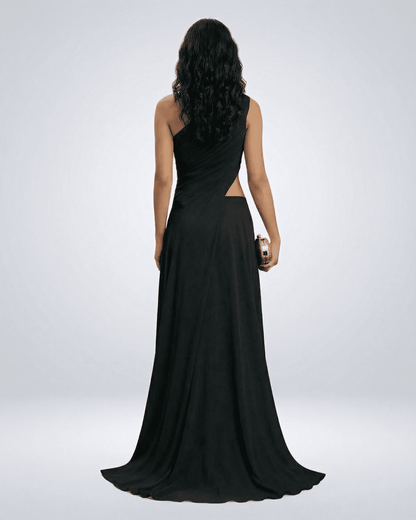 Back view of a woman wearing the Nocturne Maxi Dress by Lauven, showcasing its elegant one-shoulder design and flowing silhouette.