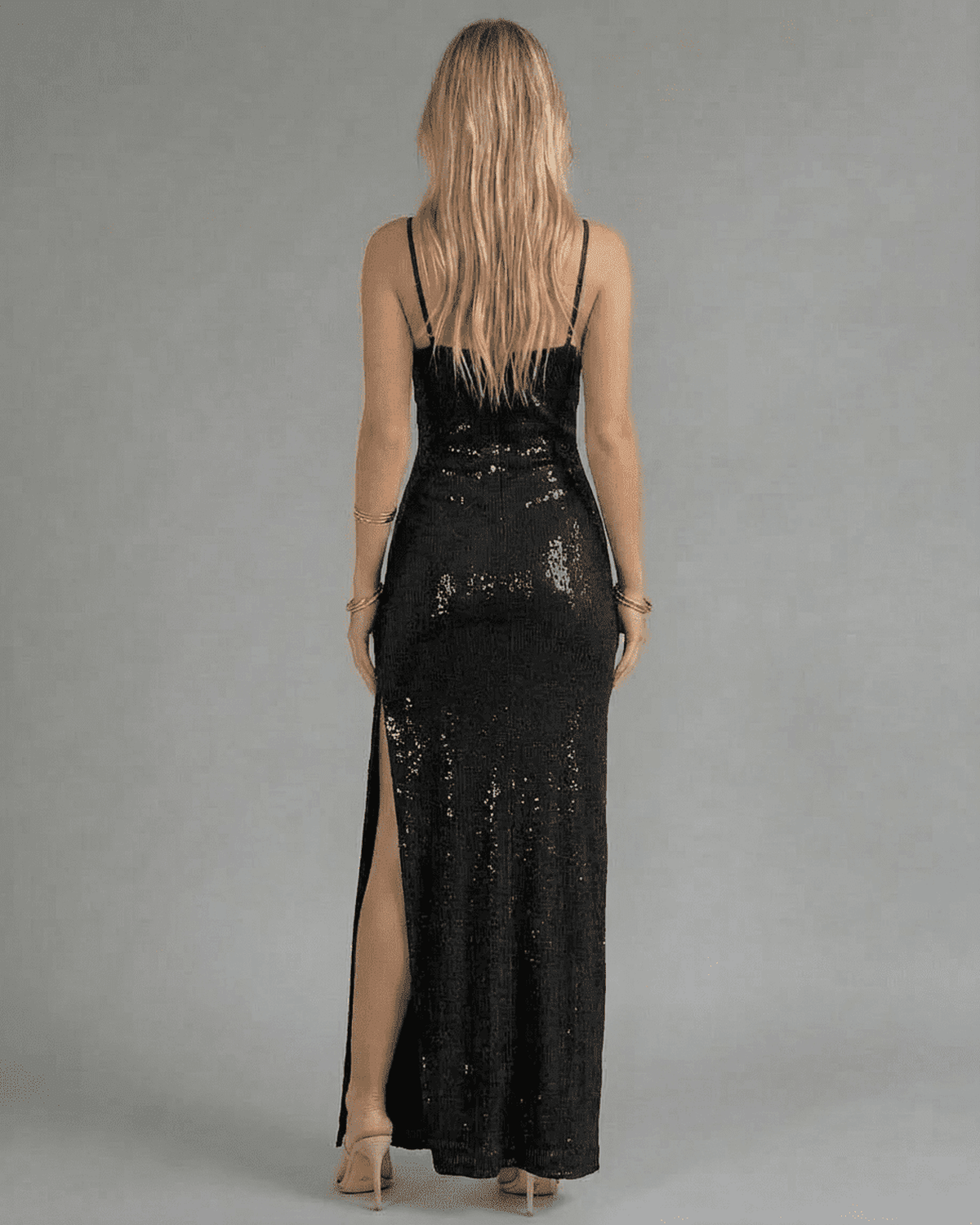 Back view of the Noir Maxi Dress by Lauven, showcasing its black sequin design and elegant slit.