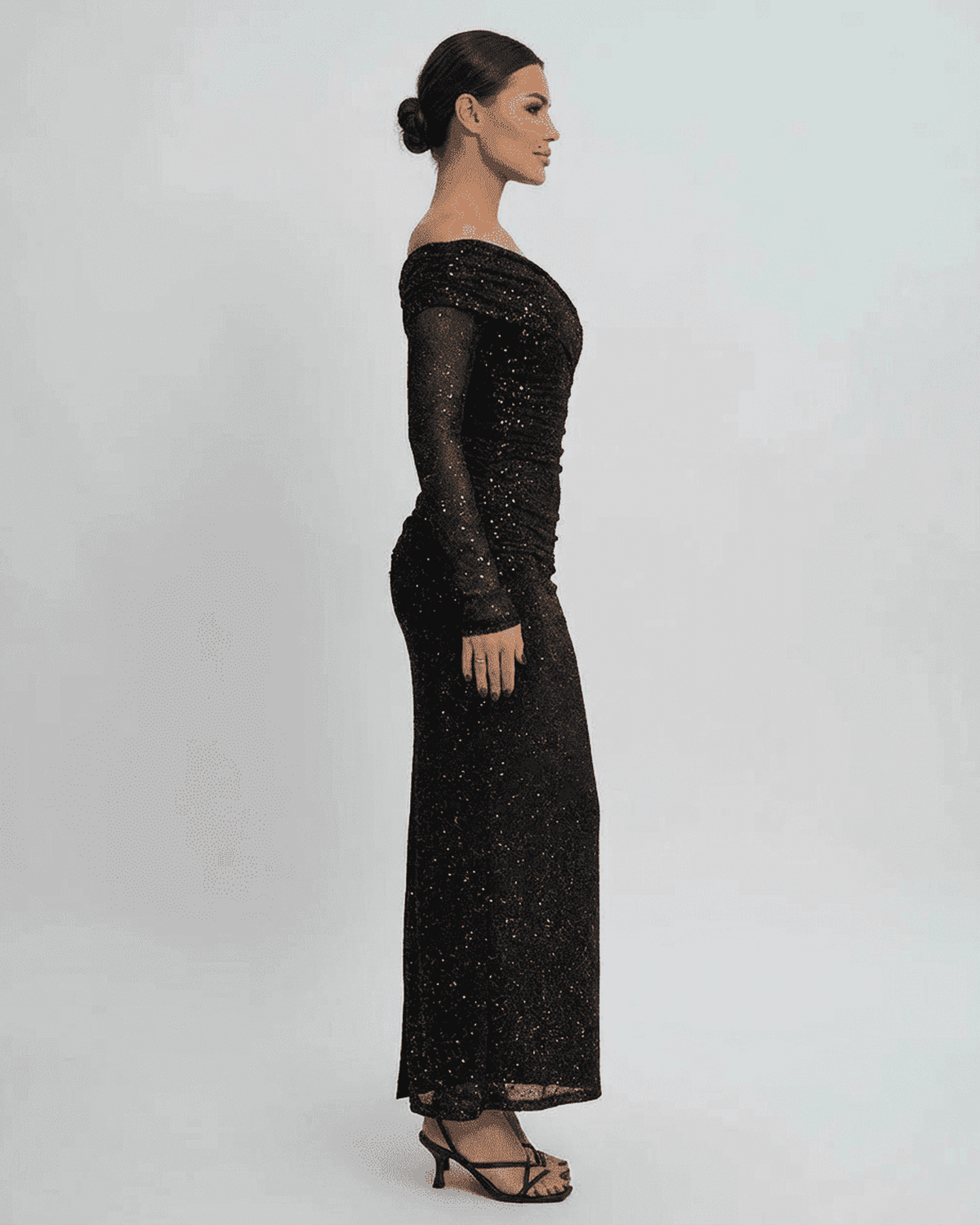 Noir Maxi Dress by Lauven - Elegant off-the-shoulder mesh gown with sequins, showcasing a side profile.