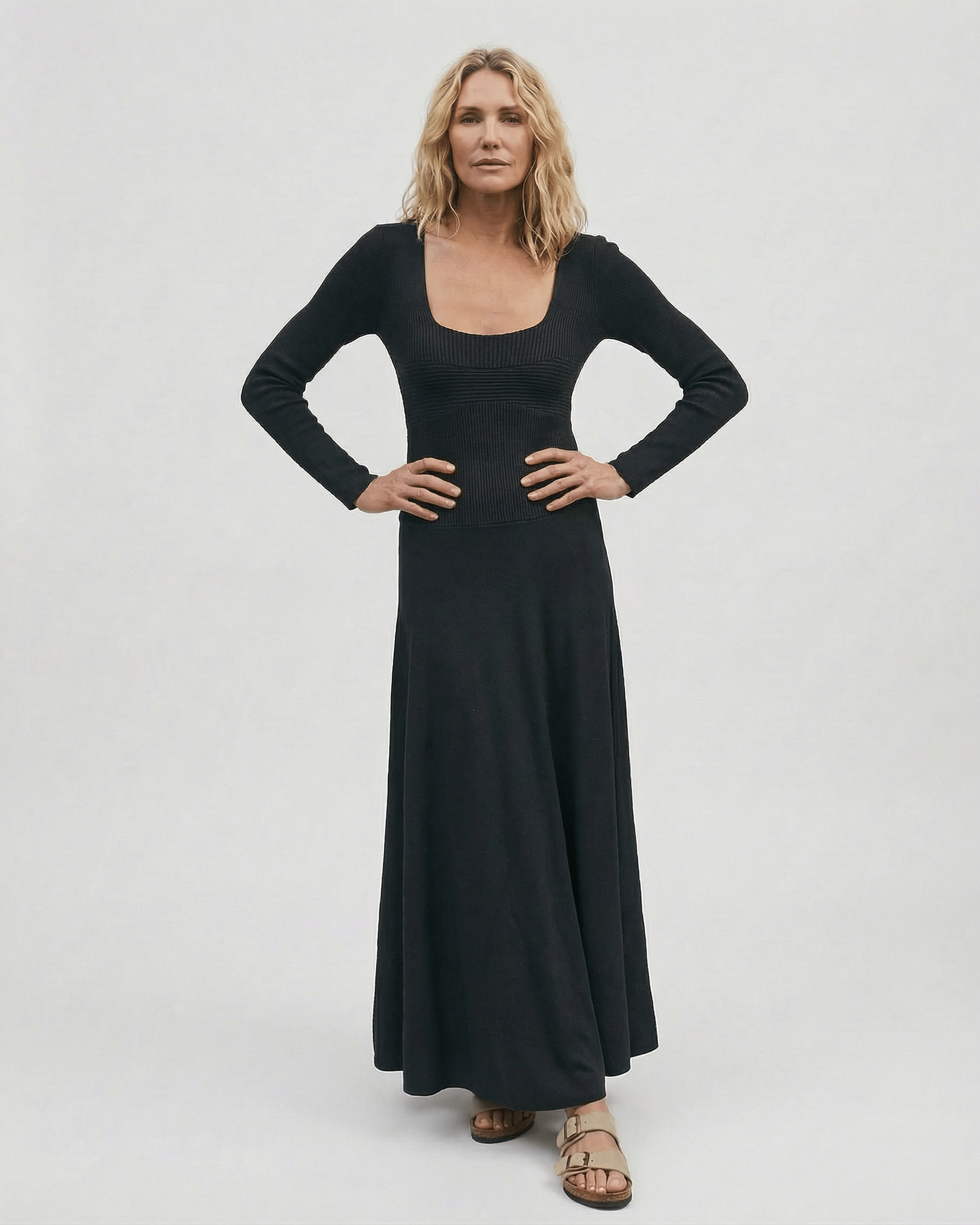 Model showcasing the Noir Maxi Dress by Lauven, featuring long sleeves and a square neckline.