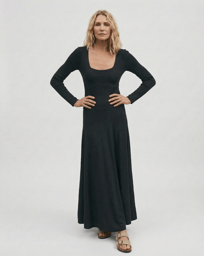 Model showcasing the Noir Maxi Dress by Lauven, featuring long sleeves and a square neckline.
