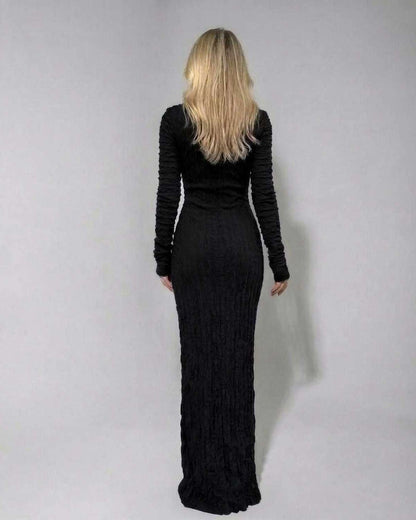 Back view of Noir Maxi Dress by Lauven, a textured black long sleeve knitted dress with a slim silhouette.