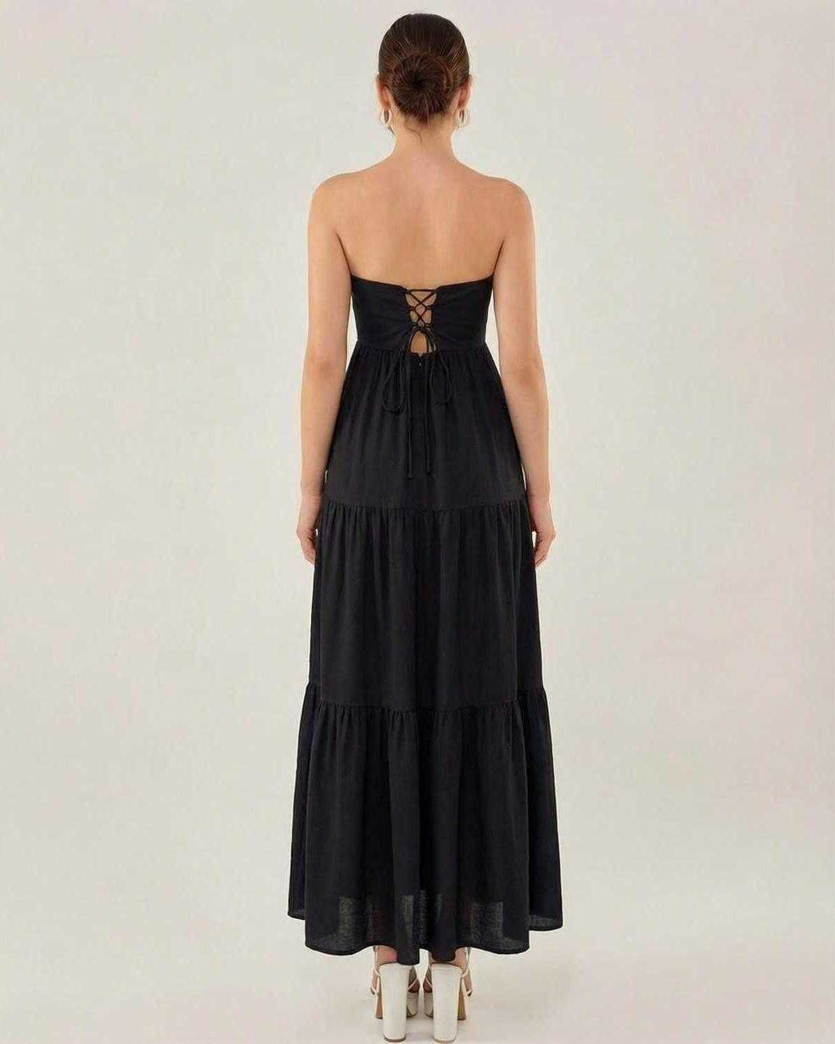 Lauven Noir Midi Dress - Elegant strapless black dress with a lace-up back and tiered design for refined occasions.
