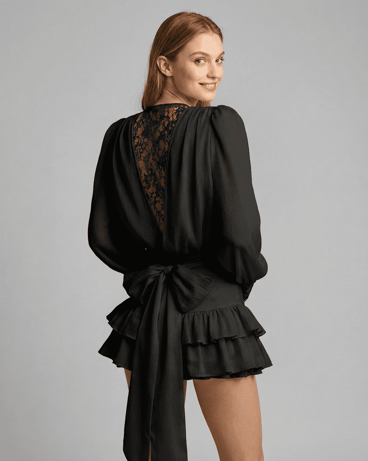 Noir Mini Dress by Lauven, showcasing lace detail and a tiered silhouette in a back view.