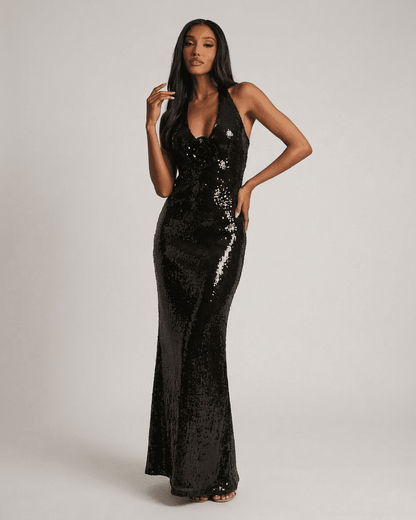 Noiré Maxi Dress by Lauven features a backless V-neck silhouette with floral sequin detail and a shimmering black finish.