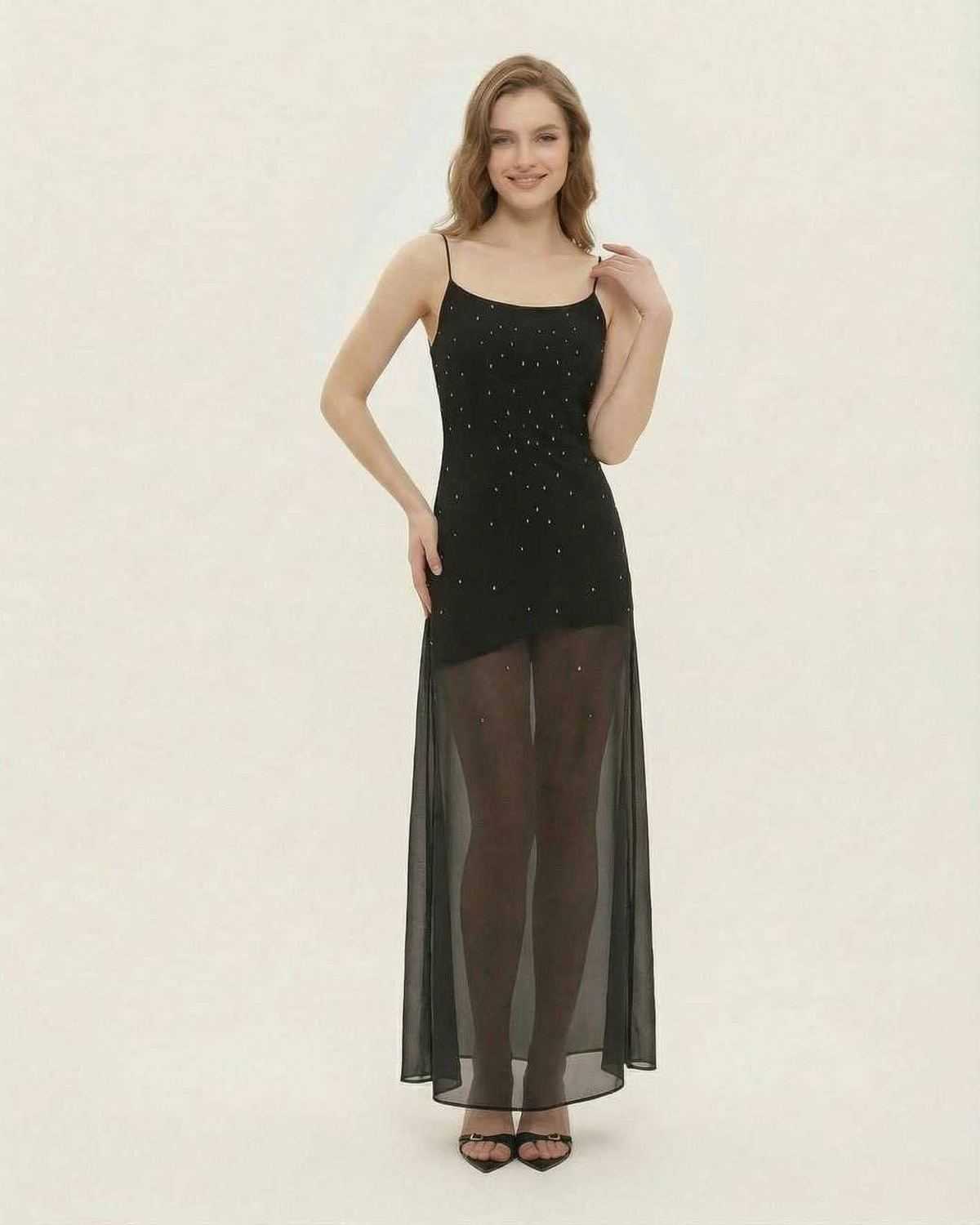 Model wearing Lauven Noire Maxi Dress, a sheer mesh A-line gown with fine glitter details and a high-waist silhouette.