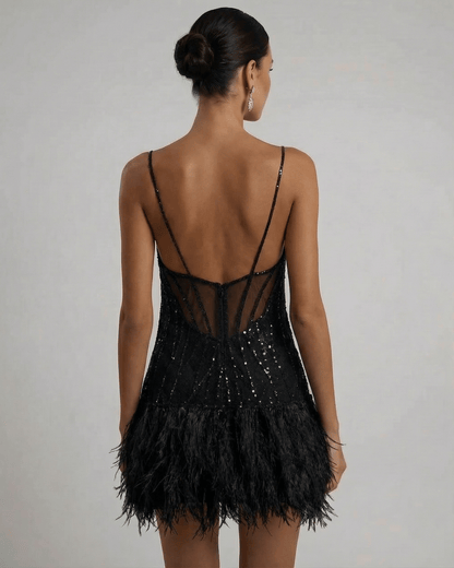 Elegant back view of the Noire Mini Dress by Lauven, showcasing the sequin tulle design and feather tassel hem.