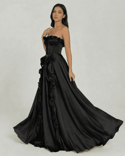 Noirelle Maxi Dress by Lauven - Elegant strapless black maxi dress with ruffle detail and flowing silhouette.