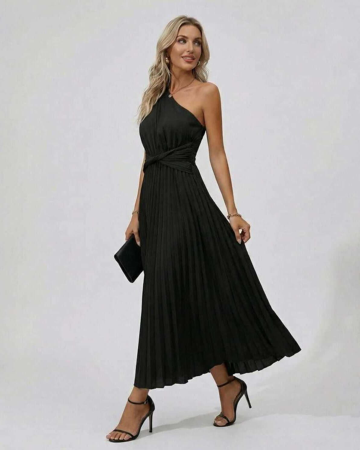 Elegant woman in Lauven Nova Midi Dress, showcasing one shoulder design and pleated hem.