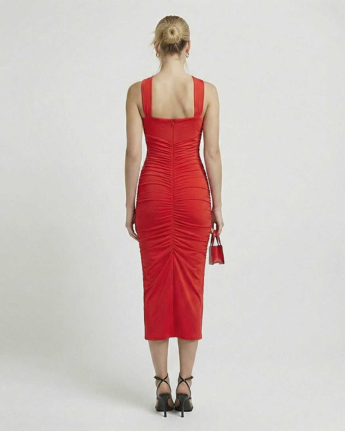 Back view of the elegant Nova Midi Dress by Lauven, showcasing its flattering sheath silhouette and strappy details.
