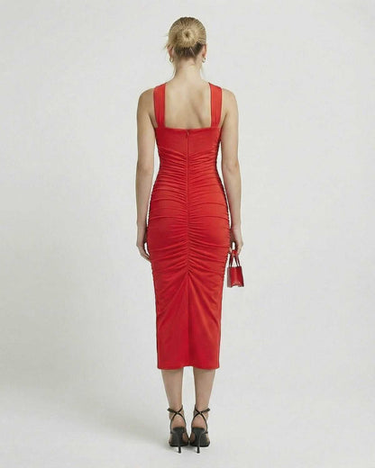 Back view of the elegant Nova Midi Dress by Lauven, showcasing its flattering sheath silhouette and strappy details.