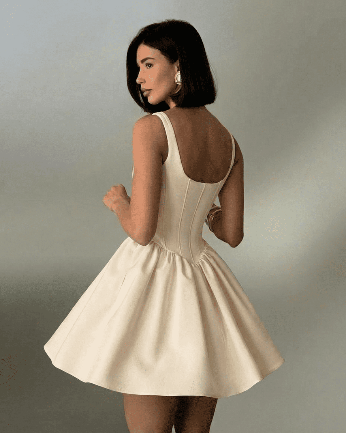 Nudea Mini Dress by Lauven showcasing a fitted corset mini dress with a flared skirt and structured back.