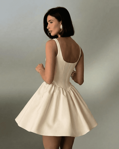 Nudea Mini Dress by Lauven showcasing a fitted corset mini dress with a flared skirt and structured back.