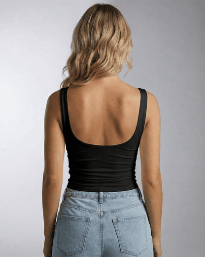 Back view of a woman wearing the Nyra Top from Lauven, featuring a sleek, sleeveless design.