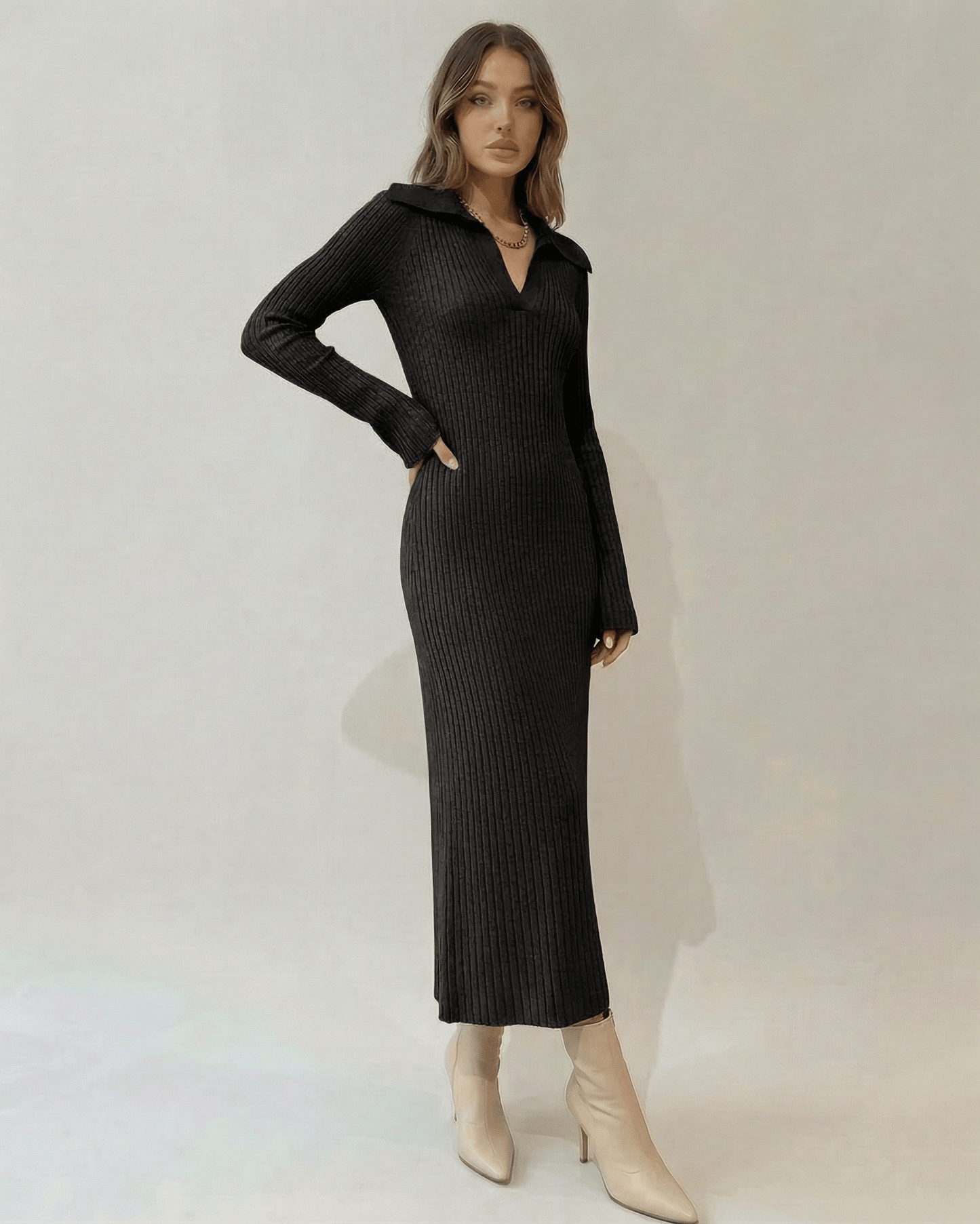 Model wearing the Nyx Midi Dress by Lauven, featuring a ribbed knit V-neck design and long sleeves.