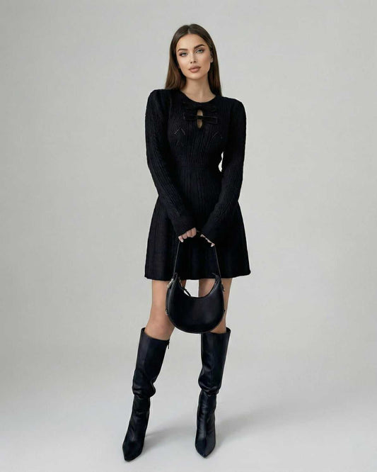 Nyx Mini Dress by Lauven, long sleeve black knit mini dress with bow detail, worn with stylish knee-high boots.