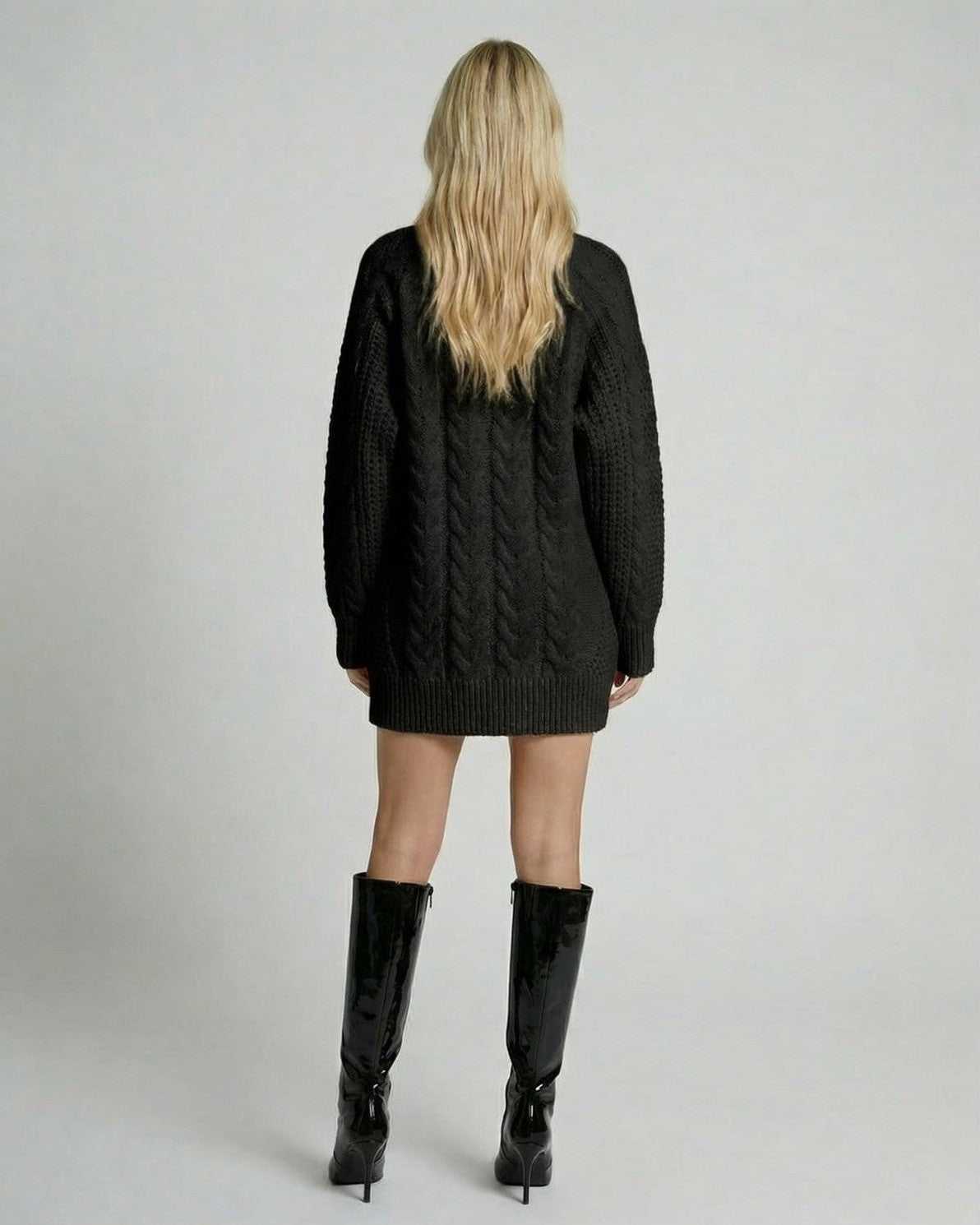 Back view of a model wearing the Nyx Sweater by Lauven, showcasing the black cable-knit design and modern casual style.