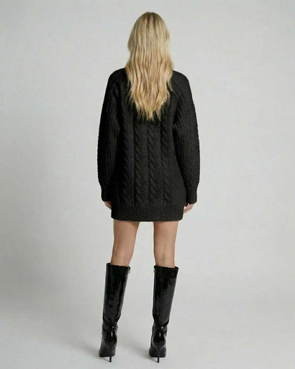Back view of a model wearing the Nyx Sweater by Lauven, showcasing the black cable-knit design and modern casual style.