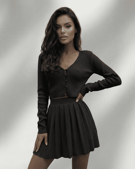 Nyx Two-Piece Set by Lauven featuring a cropped cardigan and pleated mini skirt in black.