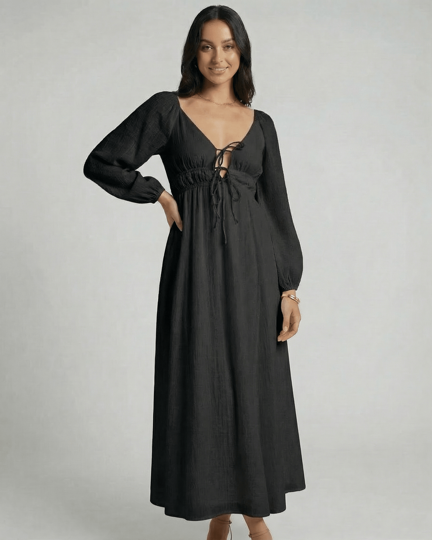 Nyxara Maxi Dress by Lauven features a black V-neck, empire waist, and fluid ankle-length design, perfect for modern wardrobes.