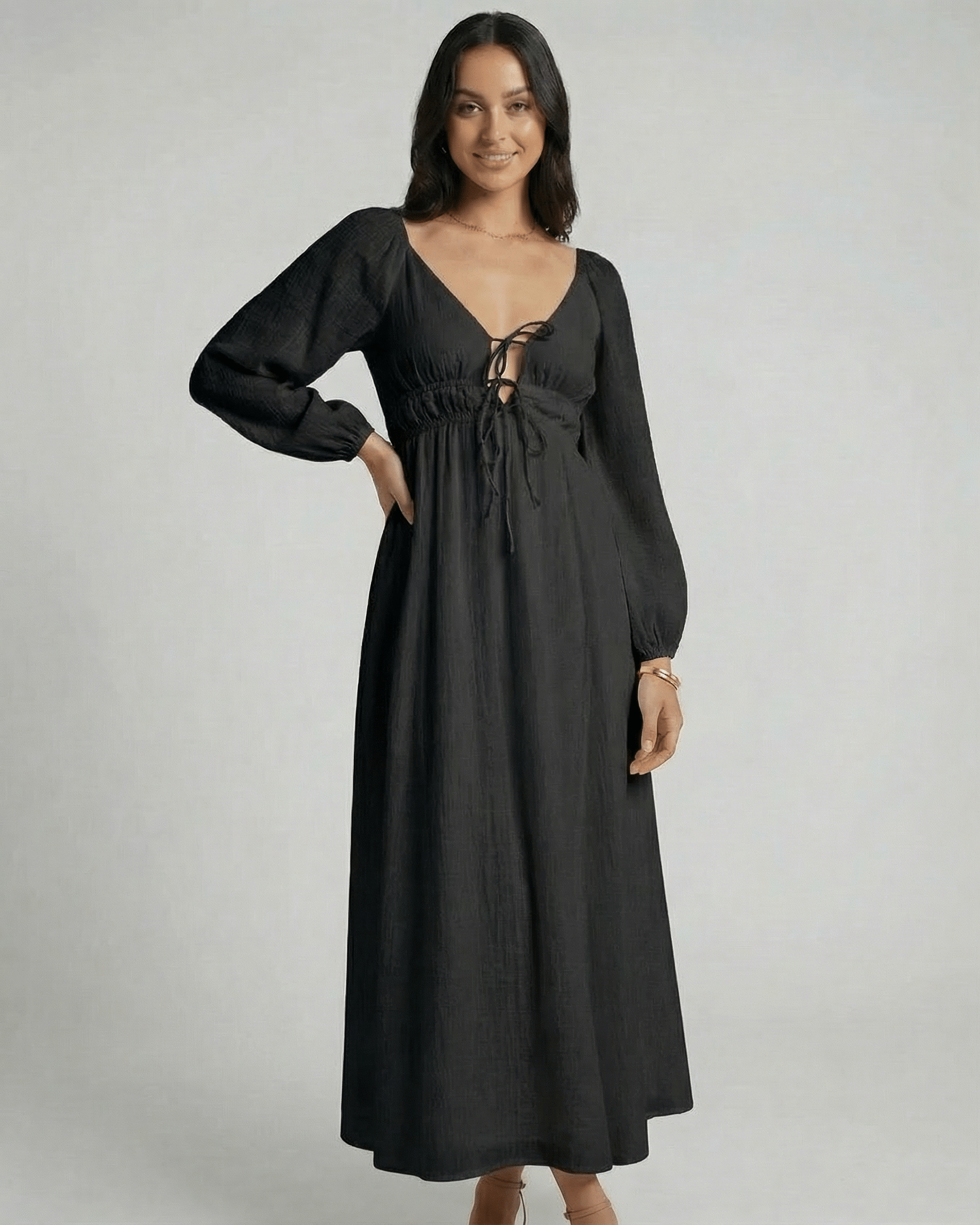 Nyxara Maxi Dress by Lauven features a black V-neck, empire waist, and fluid ankle-length design, perfect for modern wardrobes.