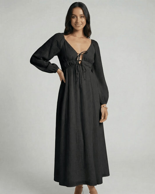 Nyxara Maxi Dress by Lauven features a black V-neck, empire waist, and fluid ankle-length design, perfect for modern wardrobes.