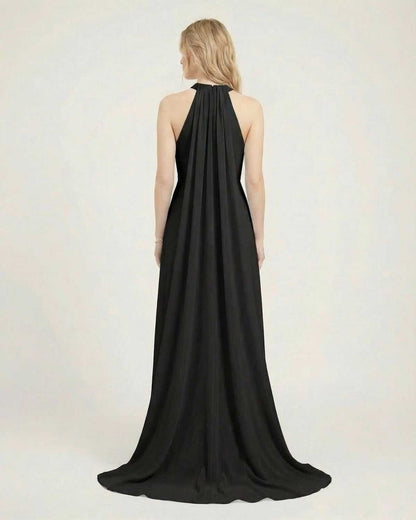 Back view of Lauven Obsidian Maxi Dress, a black halter neck sleeveless maxi dress with a loose fit.