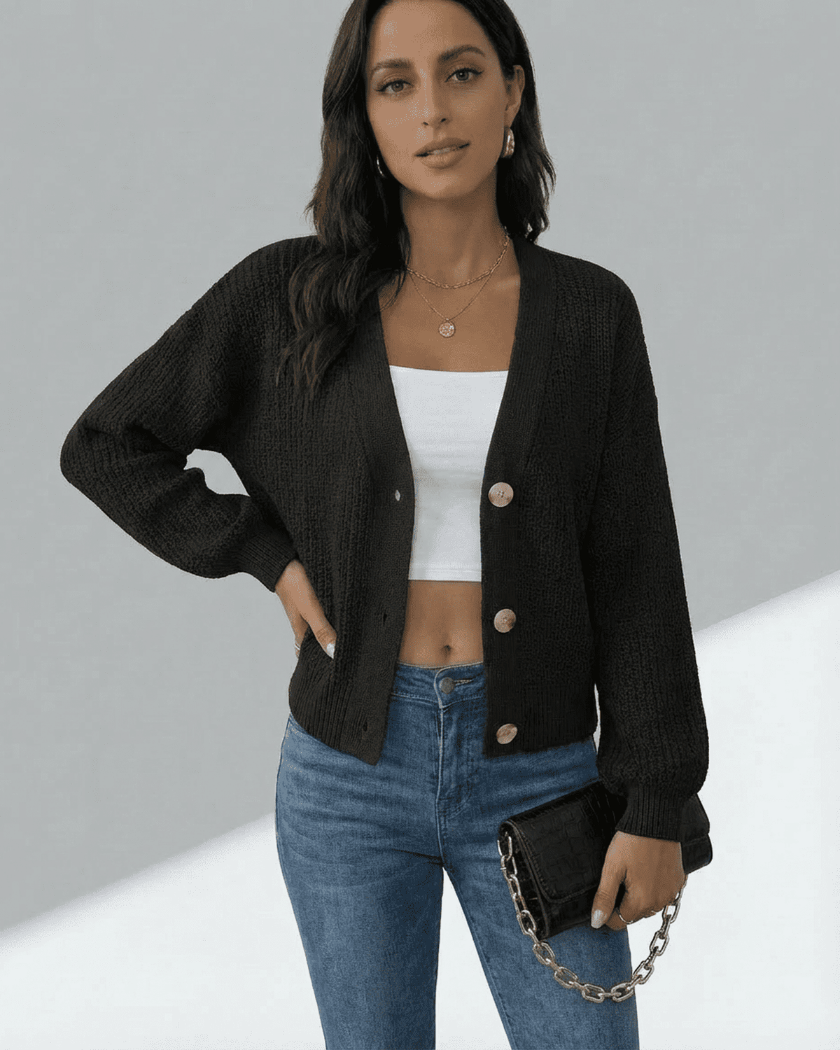 Orion Cardigan by Lauven featuring a button-front design and long sleeves, styled with jeans and a cropped top.