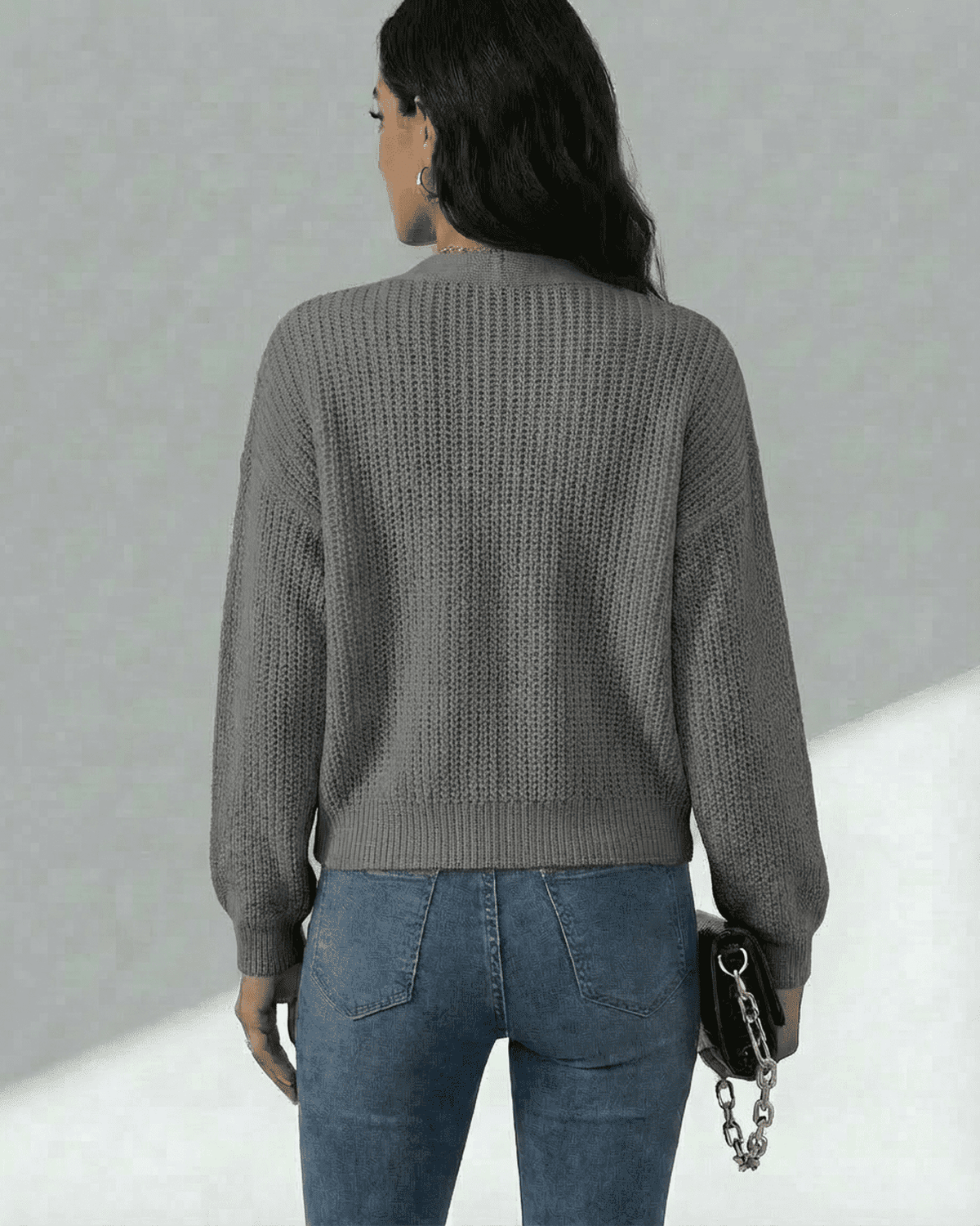 Back view of a woman wearing the Lauven Orion Cardigan in grey, showcasing textured knit and casual style.