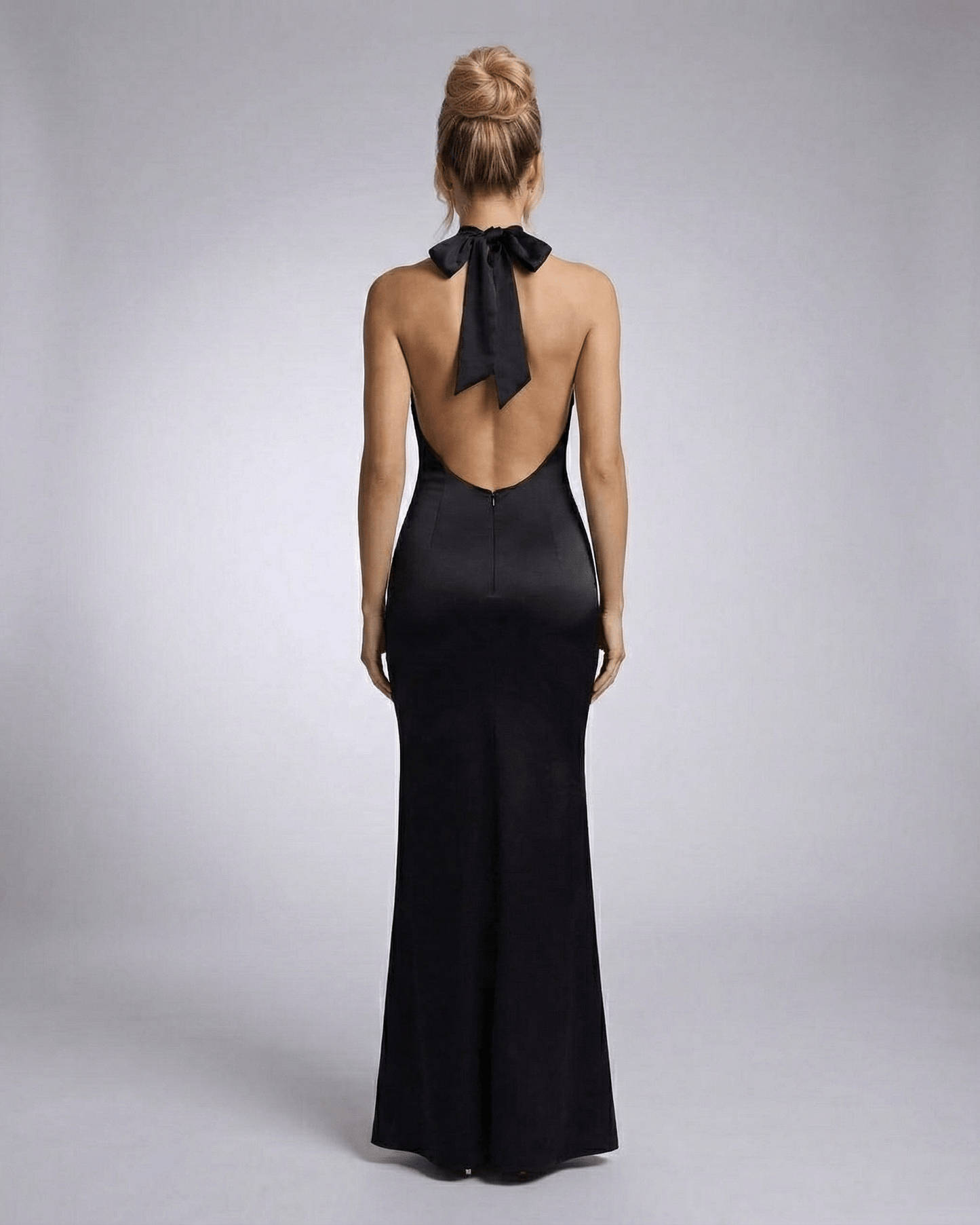 Orion Maxi Dress by Lauven, showcasing a halter neck and sleek bodycon silhouette from the back.